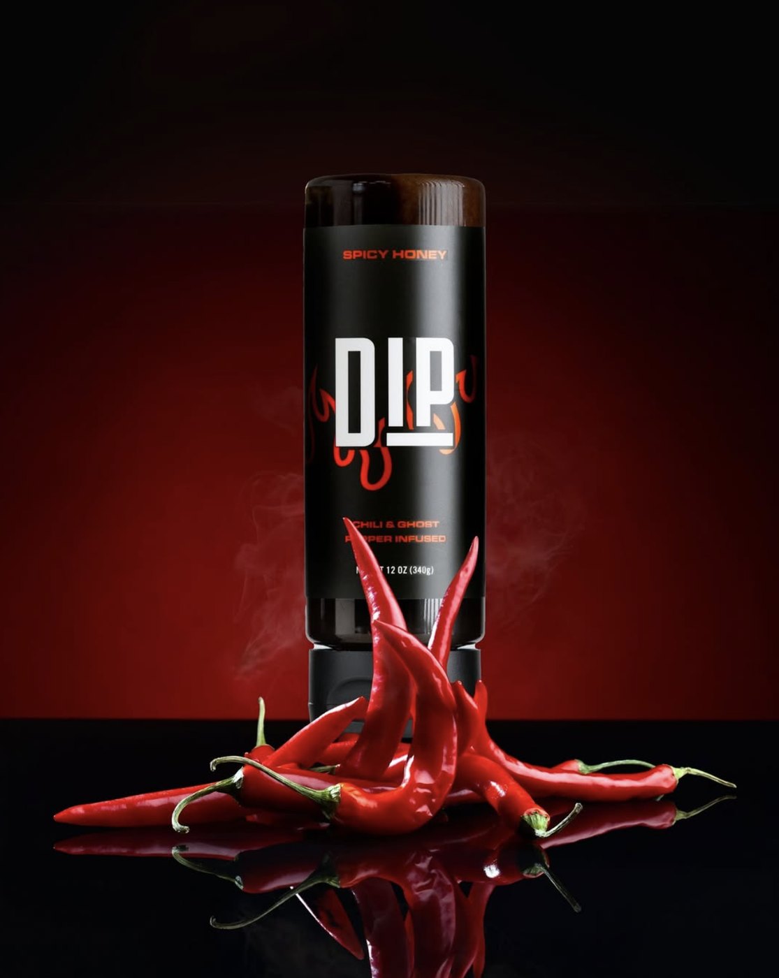 DIP spicy honey bottle surrounded by red chilies