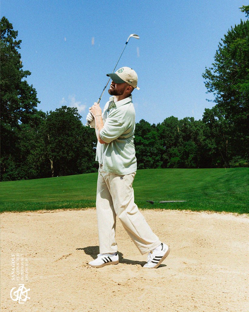 In the bunker in a sage polo and cream trousers