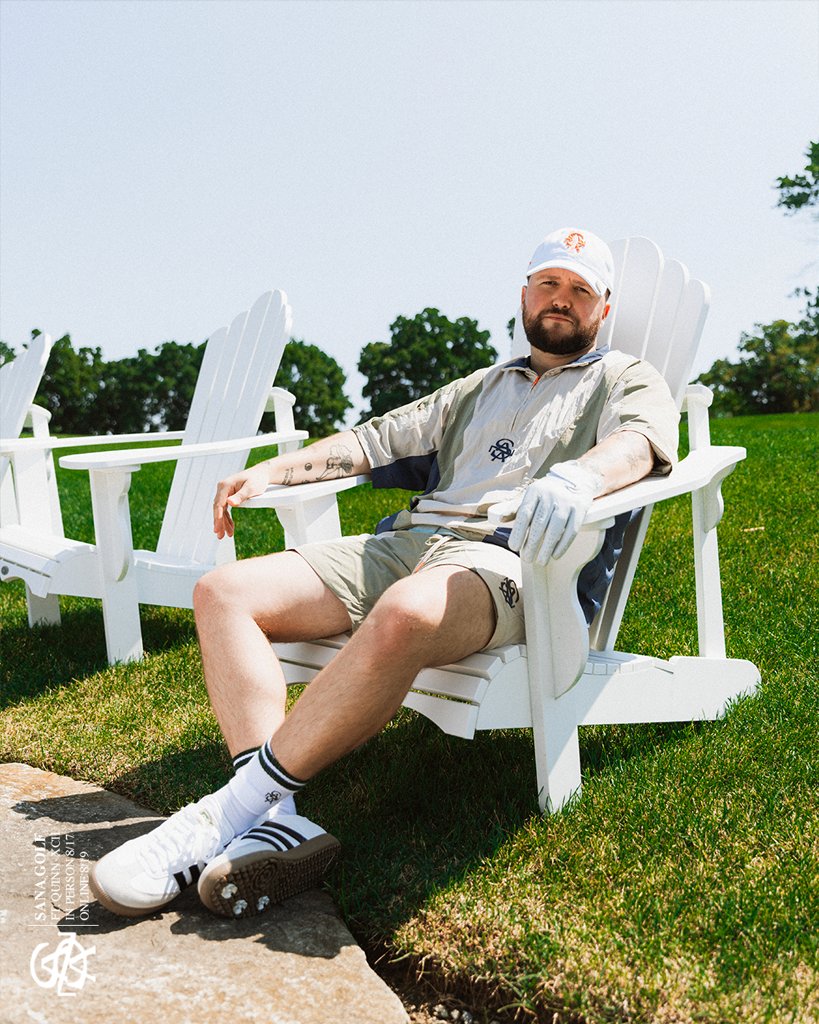Relaxing in an Adirondack chair in a khaki and navy SANA set